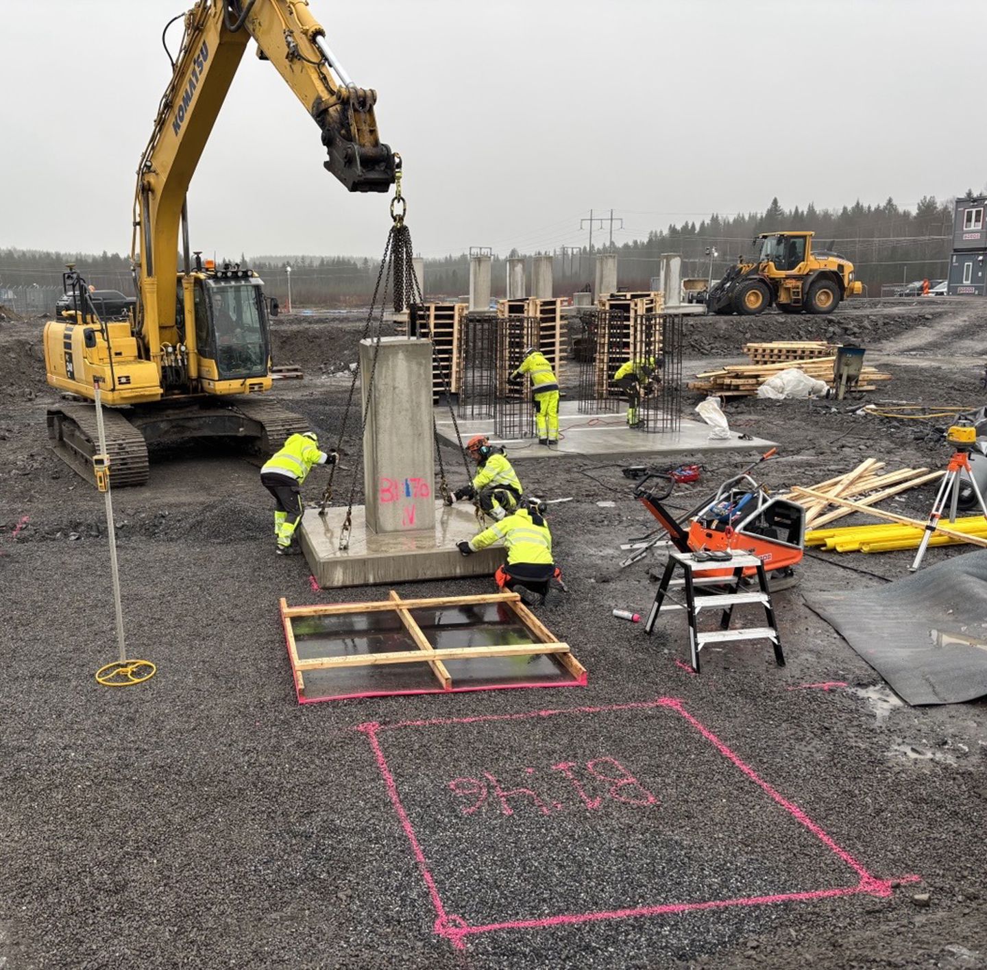 Grävmaskin lyfter betongfundament