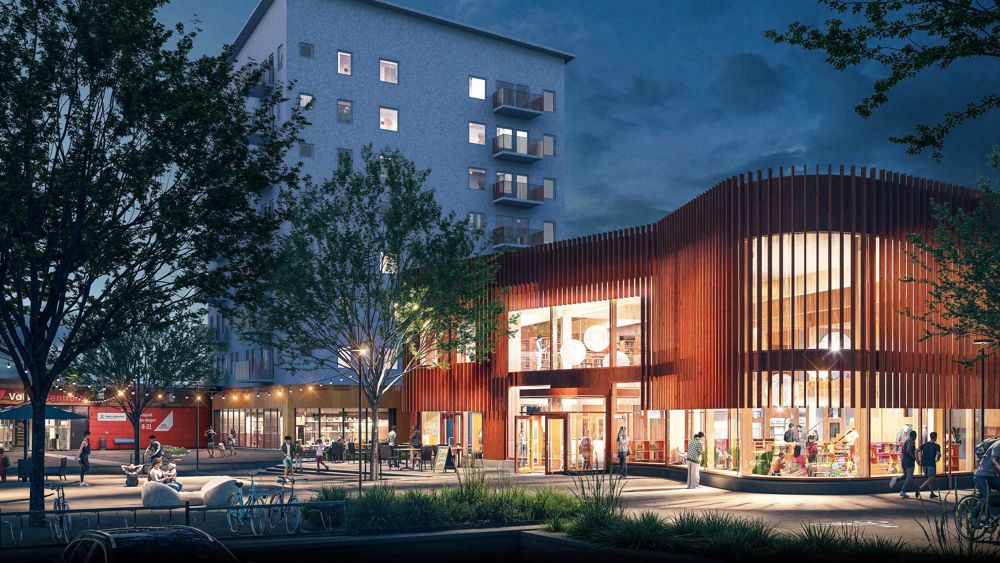 Arkitektbild av upplyst byggnad i två våningar i stadsmiljö - Valsta kultur- & aktivitetscenter