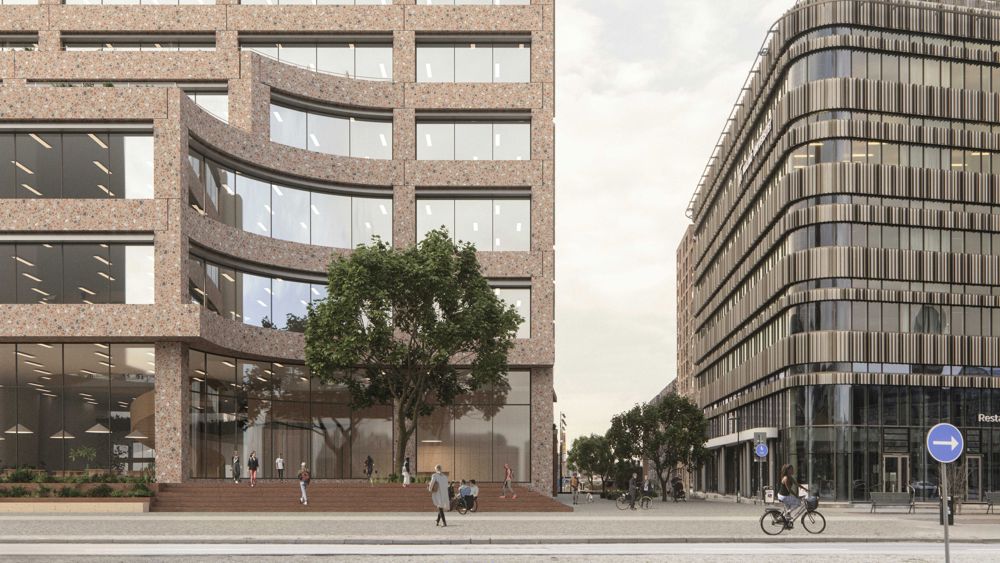Exteriördbild på modernt flervåningshus med stora glasytor och fasad i terazzo