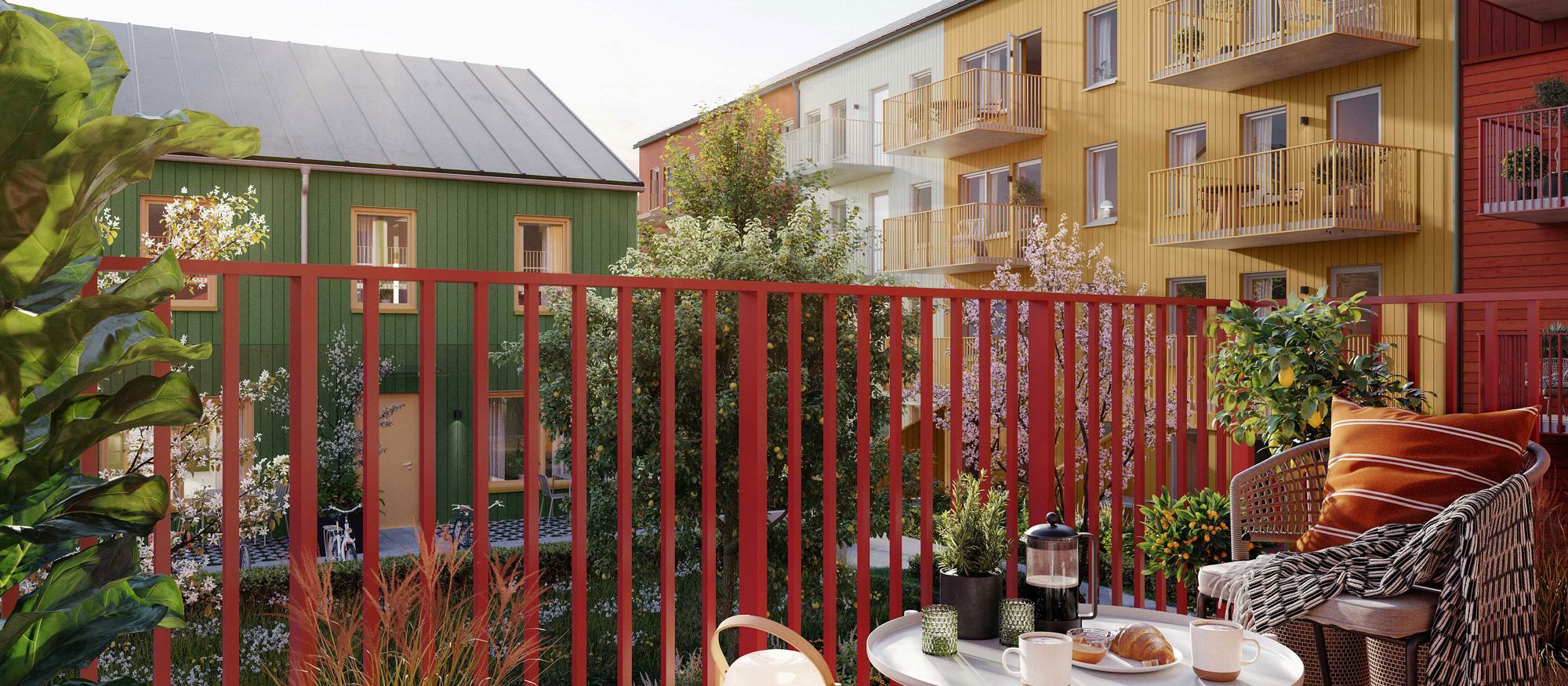 Utsikt från ombonad balkong mot innergård med färgglada flervåningshus - Brf Bolero