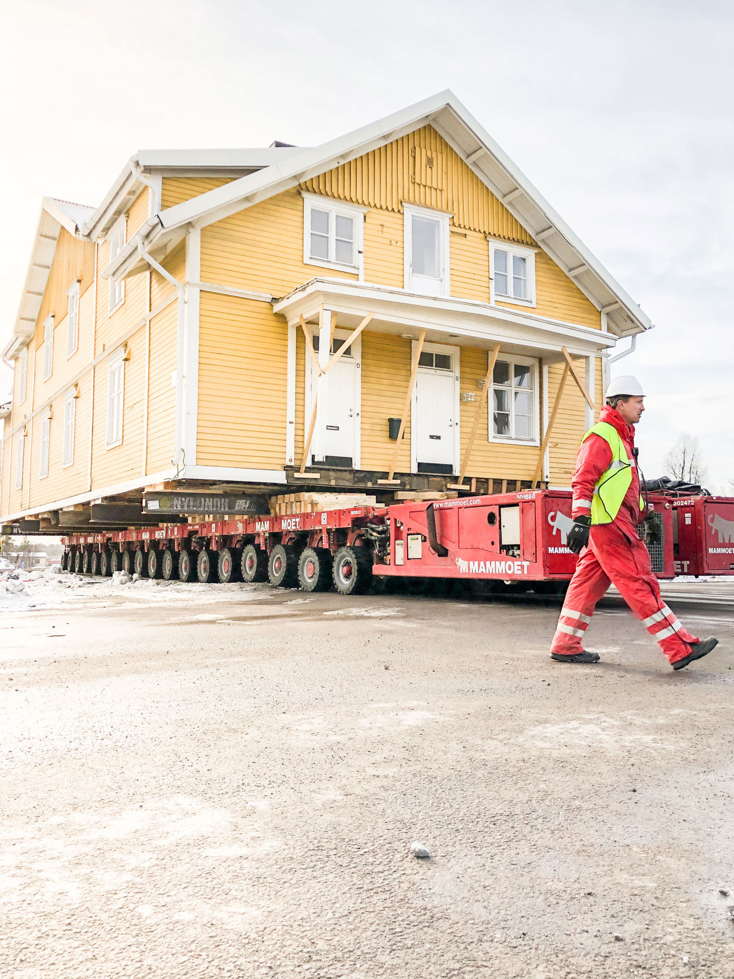 Stor gul träbyggnad rullas fram längs gatan