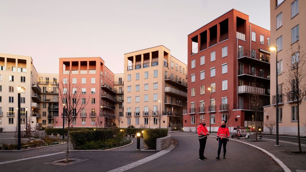 Två medarbetare tittar på ett bostadsprojekt